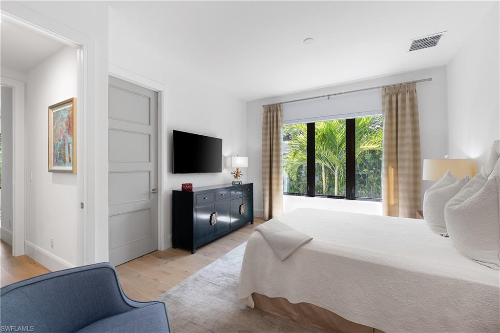 470 Wedge Drive Naples, FL 34103 - Photo 27 of 28 a living room with furniture and a flat screen tv