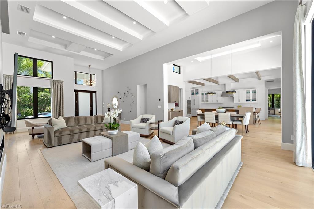 470 Wedge Drive Naples, FL 34103 - Photo 3 of 28 a living room with furniture and large windows