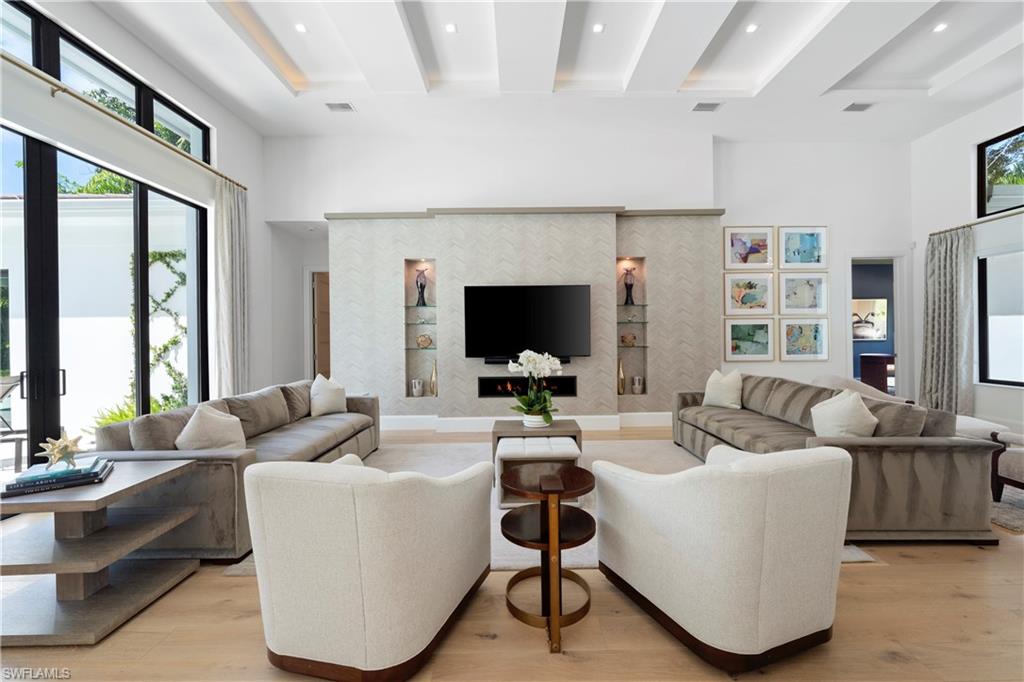 470 Wedge Drive Naples, FL 34103 - Photo 4 of 28 a living room with fireplace furniture and a flat screen tv