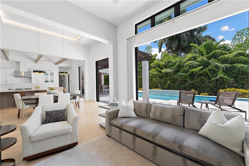 470 Wedge Drive Naples, FL 34103 - Photo 5 of 28 a living room with furniture plant and a large window