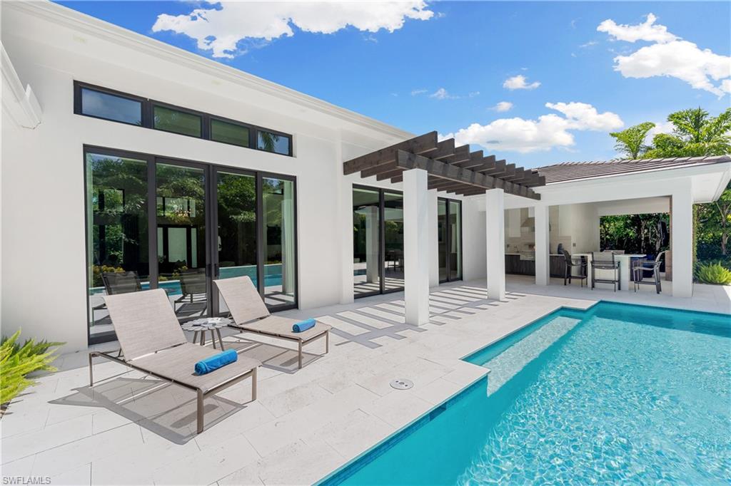 470 Wedge Drive Naples, FL 34103 - Photo 6 of 28 a view of a house with backyard porch and sitting area