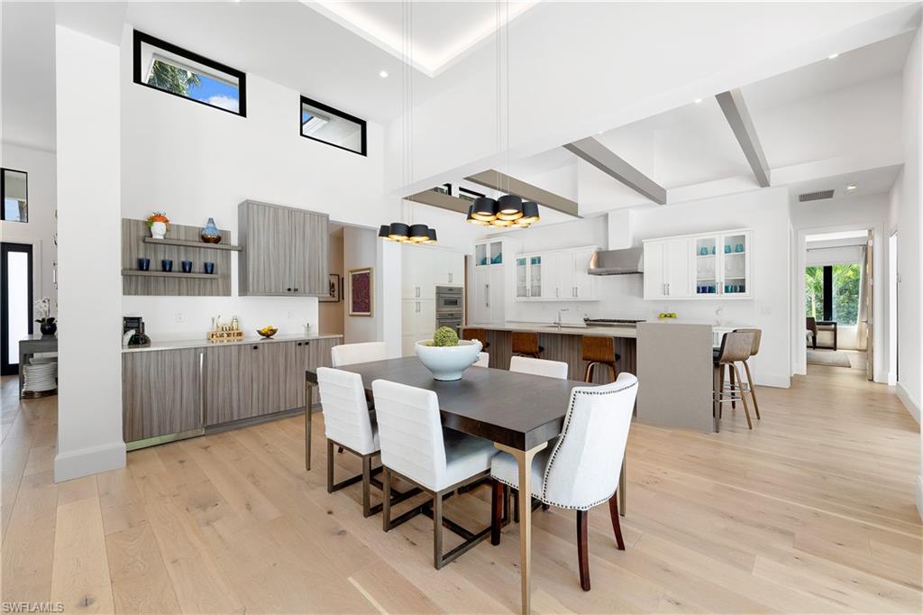 470 Wedge Drive Naples, FL 34103 - Photo 9 of 28 a view of a dining room with furniture and wooden floor