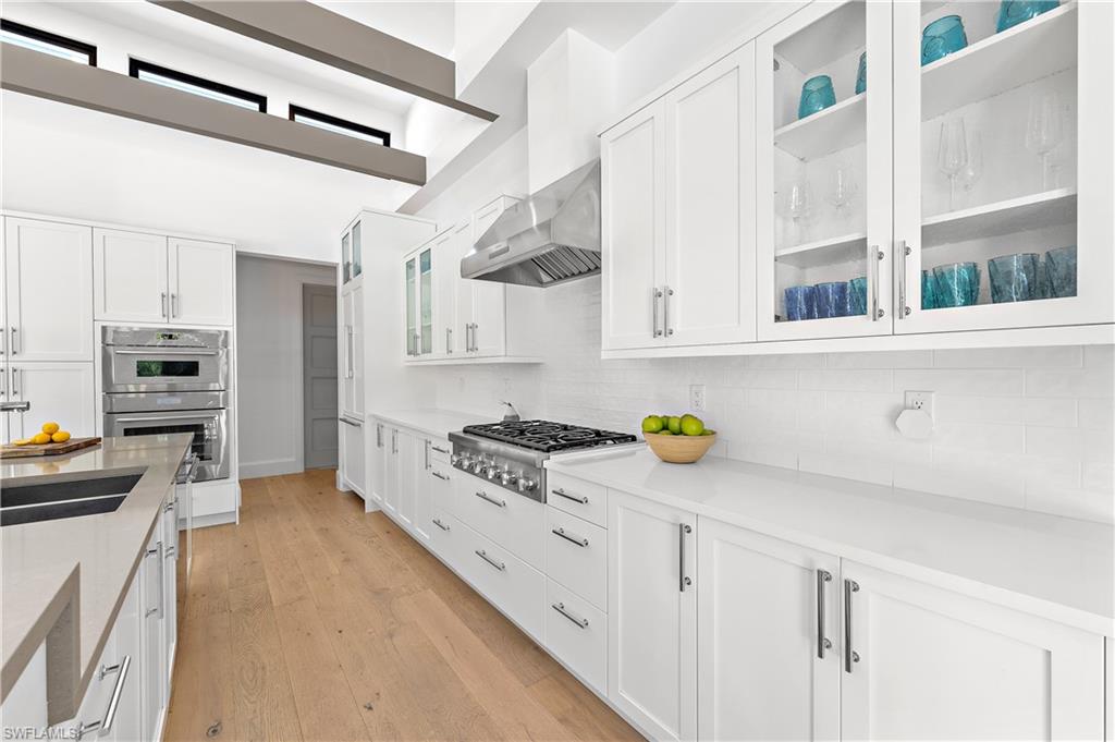 470 Wedge Drive Naples, FL 34103 - Photo 10 of 28 a kitchen with stainless steel appliances a stove a sink and a refrigerator