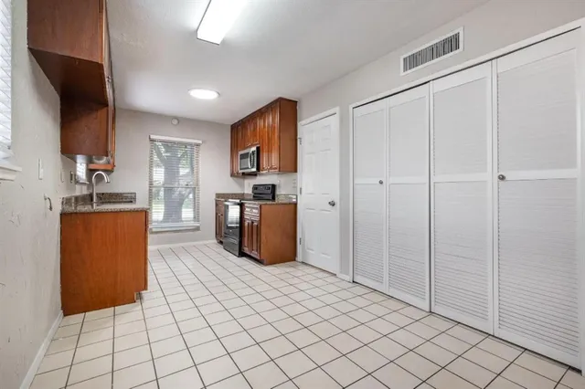 a large white kitchen with cabinets
