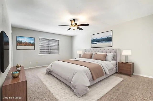 a bedroom with bed and a chandelier