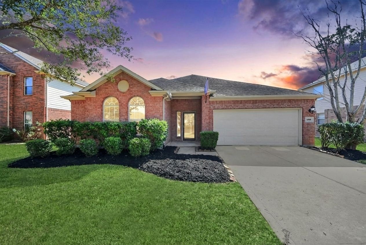 Charming single-story brick home with a two-car garage. Features a manicured lawn, neat shrubs, and a welcoming entrance. With a 2026 Brand New Roof !