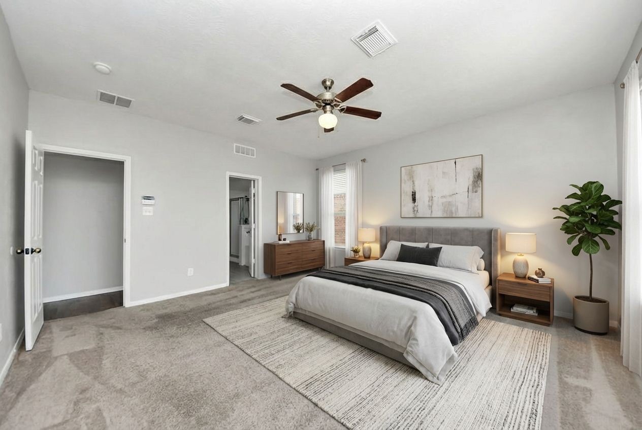 2306 2 Trail Drive Spring, TX 77373 - Photo 14 of 27 Spacious and bright Primary bedroom with neutral tones, featuring large windows for ample natural light. Includes a ceiling fan and carpeted floor for comfort.
