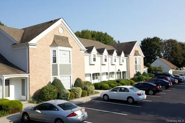 a view of cars parked in front of a house