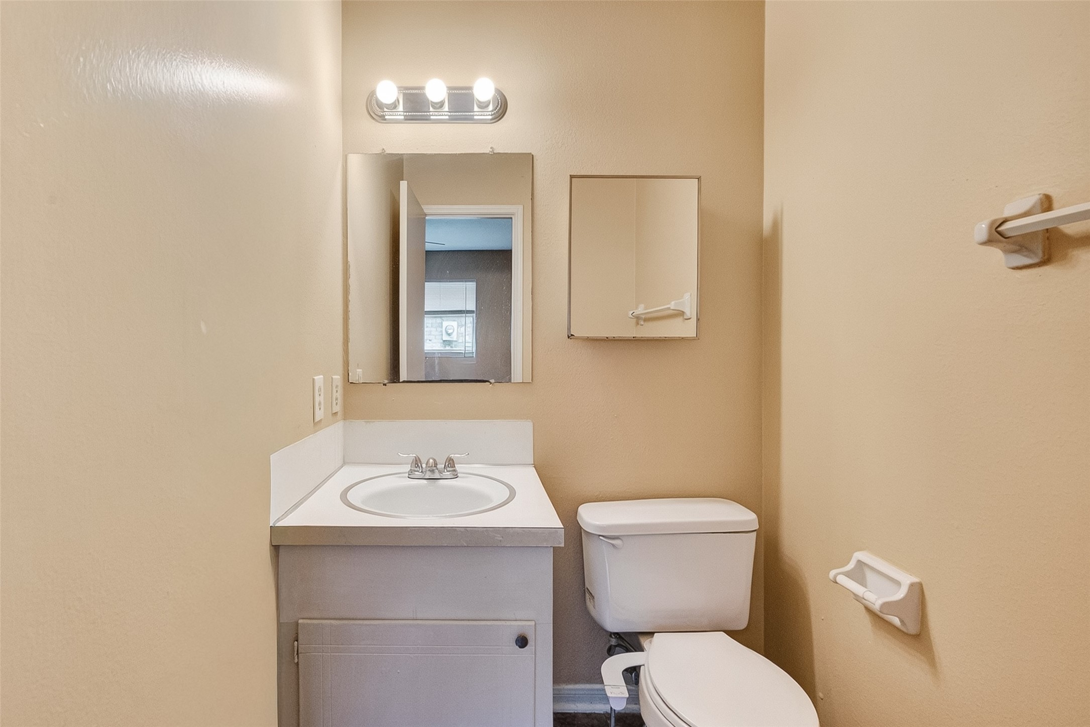 4826 Redfish Reef Drive Bacliff, TX 77518 - Photo 21 of 25 a bathroom with a toilet a sink and mirror