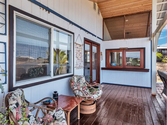 a balcony view with furniture and wooden floor
