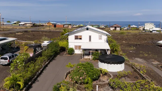 an aerial view of a houses with a yard