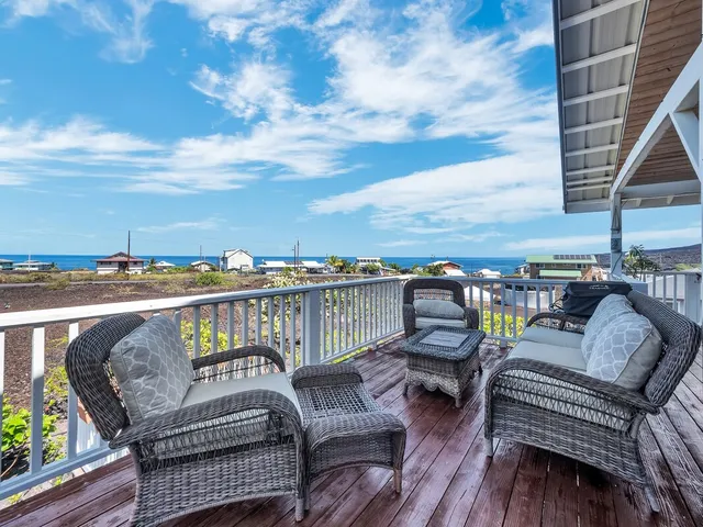 a view of a balcony with seating space