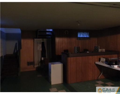 25 Rector Avenue Woodbridge, NJ 07095 - Photo 11 of 14 a kitchen with a refrigerator and cabinets