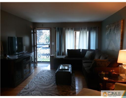25 Rector Avenue Woodbridge, NJ 07095 - Photo 13 of 14 a living room with furniture and a flat screen tv