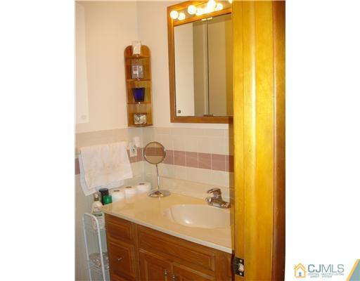25 Rector Avenue Woodbridge, NJ 07095 - Photo 5 of 14 a bathroom with a sink and a mirror