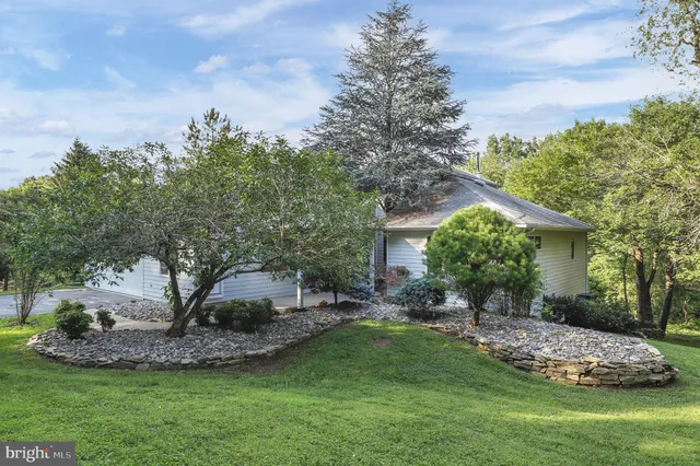 a view of a house with a yard and sitting area