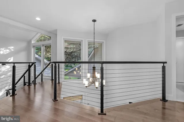 a view of a small space with wooden floor and a window