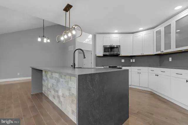 a kitchen with stainless steel appliances granite countertop a sink and a stove