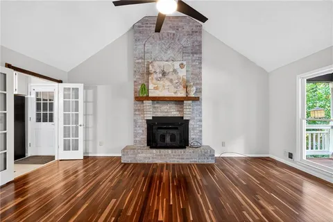a view of a livingroom with wooden floor and fireplace