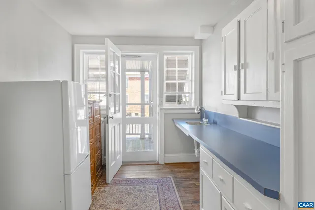 a kitchen with stainless steel appliances granite countertop a sink and a granite counter tops with a large window