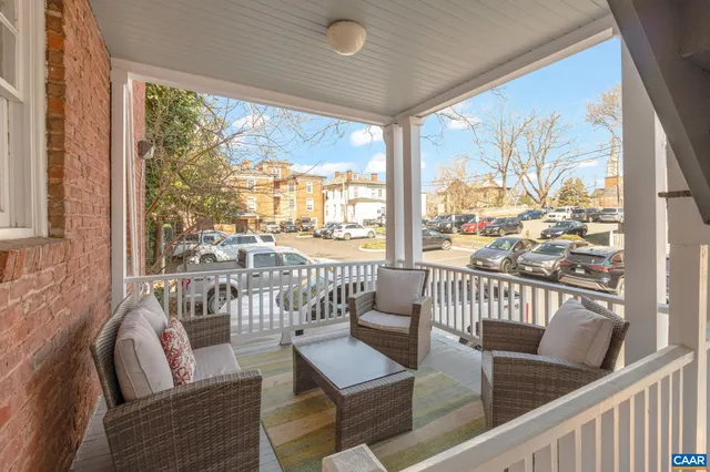 a view of a living room and a floor to ceiling window with wooden floor
