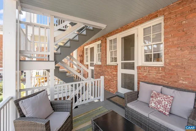 a living room with furniture and stairs