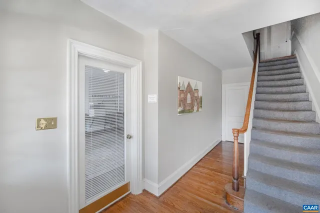 a view of a hallway with wooden floor and entryway