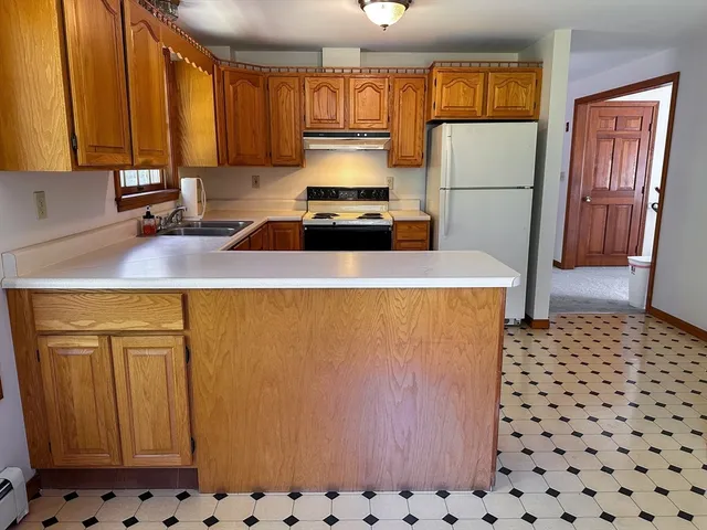 a kitchen with a refrigerator and a stove