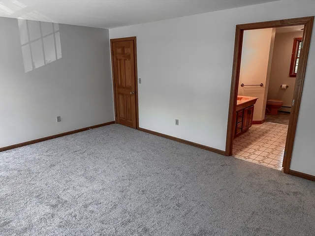 a bathroom with a sink a toilet and mirror