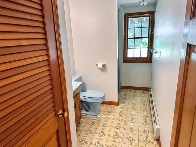 an empty room with windows and fireplace