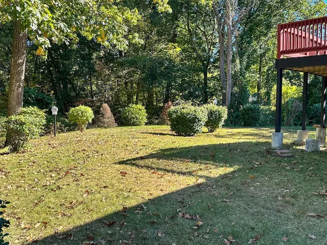 an aerial view of a house with a yard table and chairs