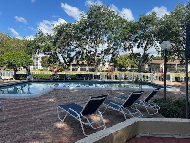 1985 Southwest 15th Street, Unit 126 Deerfield Beach, FL 33442 - Photo 1 of 27 a view of a chairs and table on the terrace