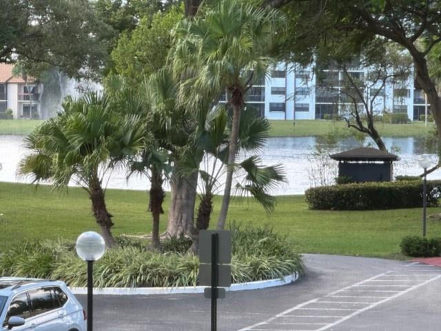 1985 Southwest 15th Street, Unit 126 Deerfield Beach, FL 33442 - Photo 15 of 27 a front view of a house with garden