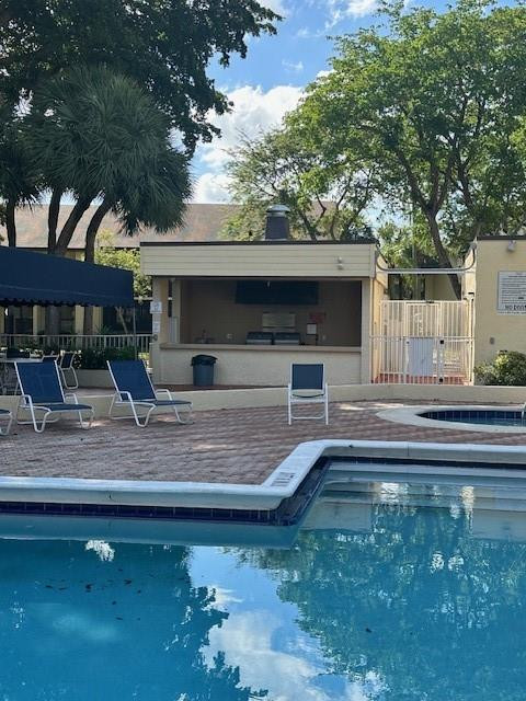 1985 Southwest 15th Street, Unit 126 Deerfield Beach, FL 33442 - Photo 20 of 27 a view of a swimming pool with a patio