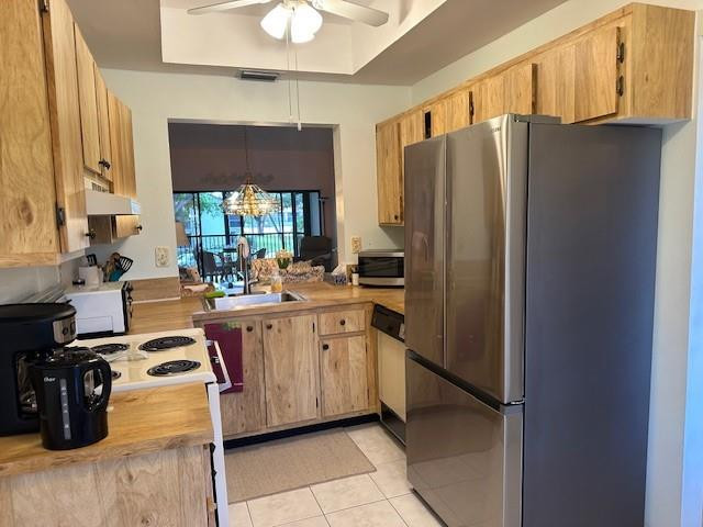 1985 Southwest 15th Street, Unit 126 Deerfield Beach, FL 33442 - Photo 4 of 27 a kitchen with stainless steel appliances a refrigerator sink and white cabinets