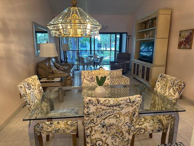 1985 Southwest 15th Street, Unit 126 Deerfield Beach, FL 33442 - Photo 6 of 27 a living room with furniture and a chandelier