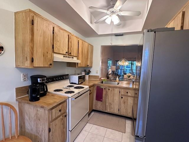 1985 Southwest 15th Street, Unit 126 Deerfield Beach, FL 33442 - Photo 8 of 27 a kitchen with stainless steel appliances granite countertop a stove a sink and a refrigerator
