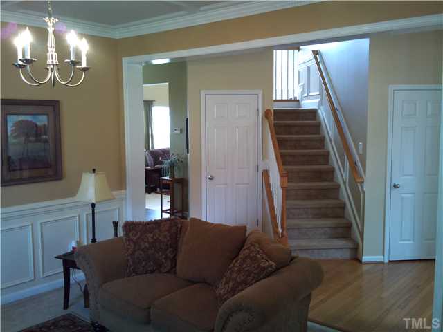 108 Riley Oaks Lane Apex, NC 27539 - Photo 10 of 22 Gorgeous Wainscoting adorns the Living Room and Staircase areas!