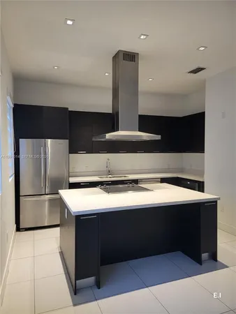 a kitchen with a sink stainless steel appliances and cabinets