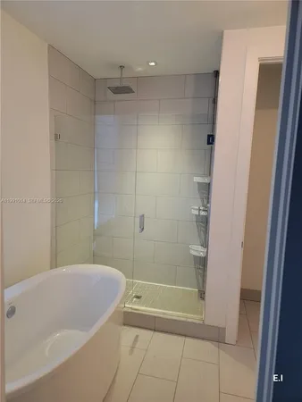 a bathroom with a bathtub and shower