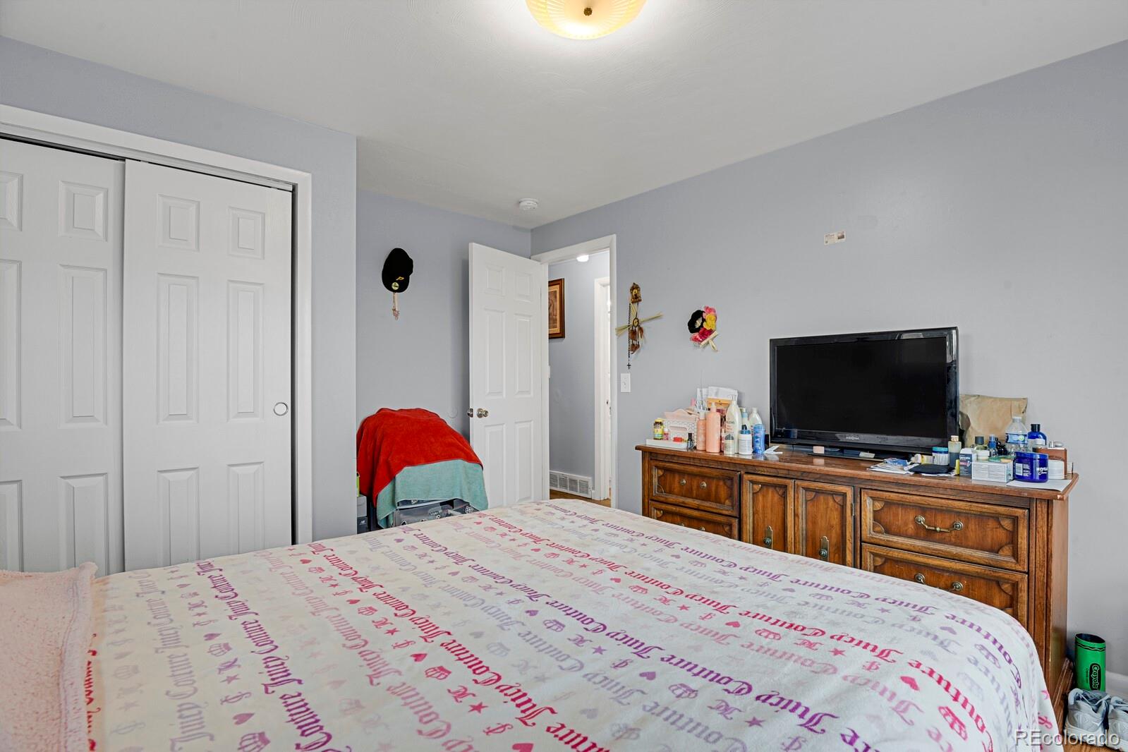 233 South Decatur Street Denver, CO 80219 - Photo 11 of 35 a bedroom with a bed and a flat screen tv