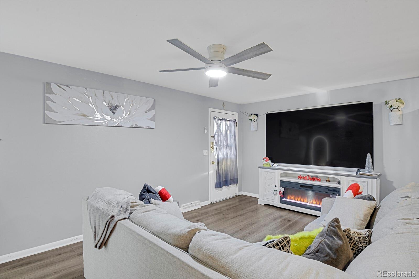 233 South Decatur Street Denver, CO 80219 - Photo 20 of 35 a living room with furniture and a flat screen tv