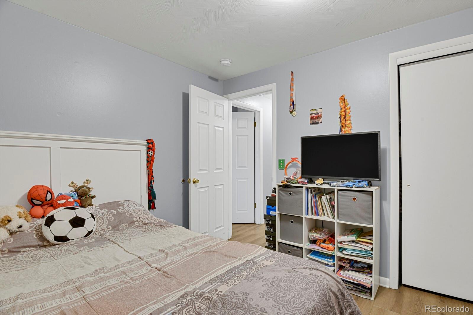 233 South Decatur Street Denver, CO 80219 - Photo 30 of 35 a bedroom with a bed and a flat screen tv