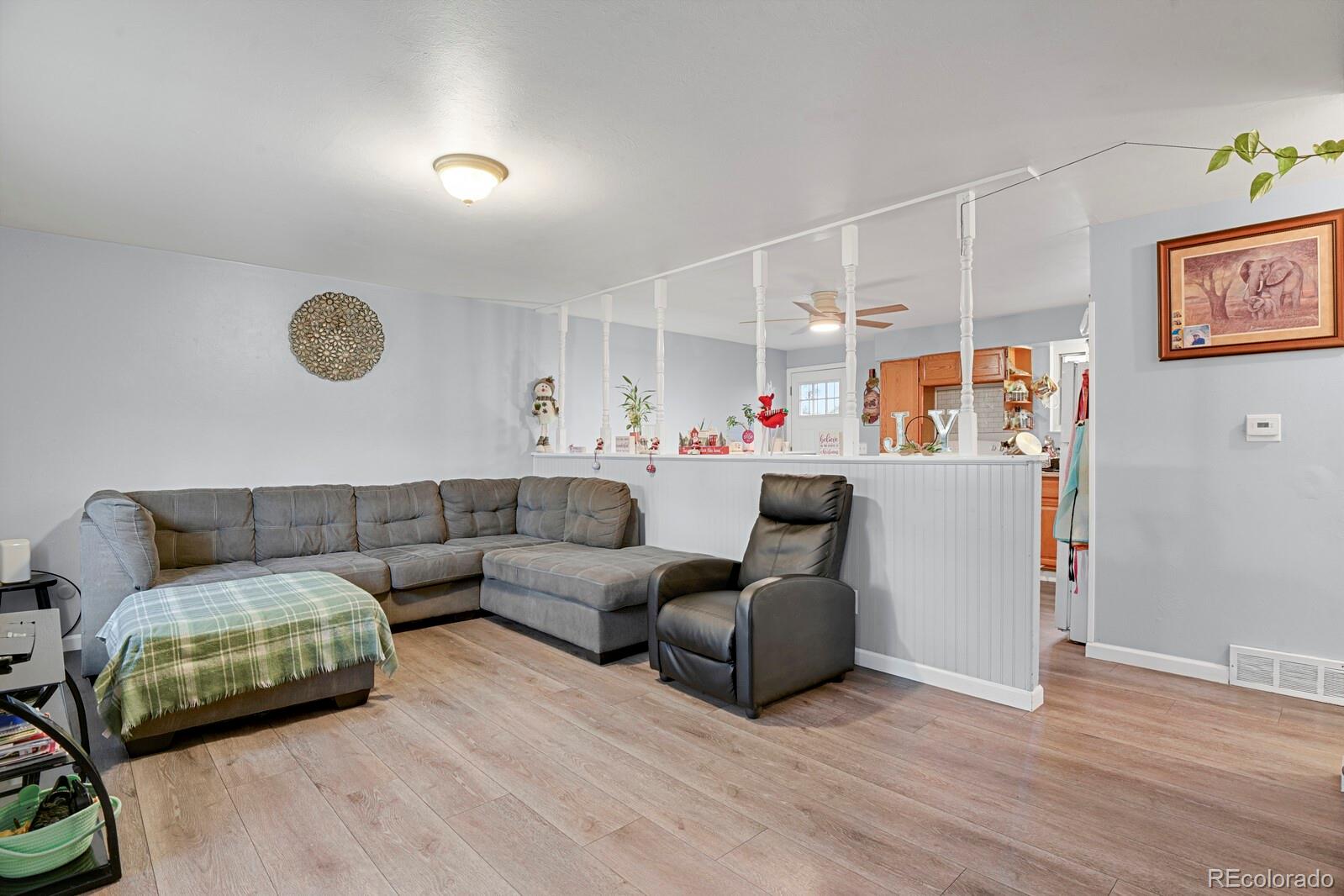 233 South Decatur Street Denver, CO 80219 - Photo 4 of 35 a living room with furniture and a window