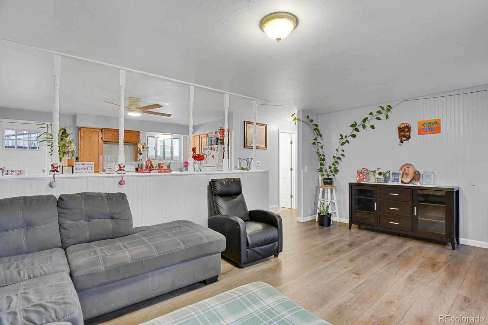 233 South Decatur Street Denver, CO 80219 - Photo 6 of 35 a living room with furniture and a dresser