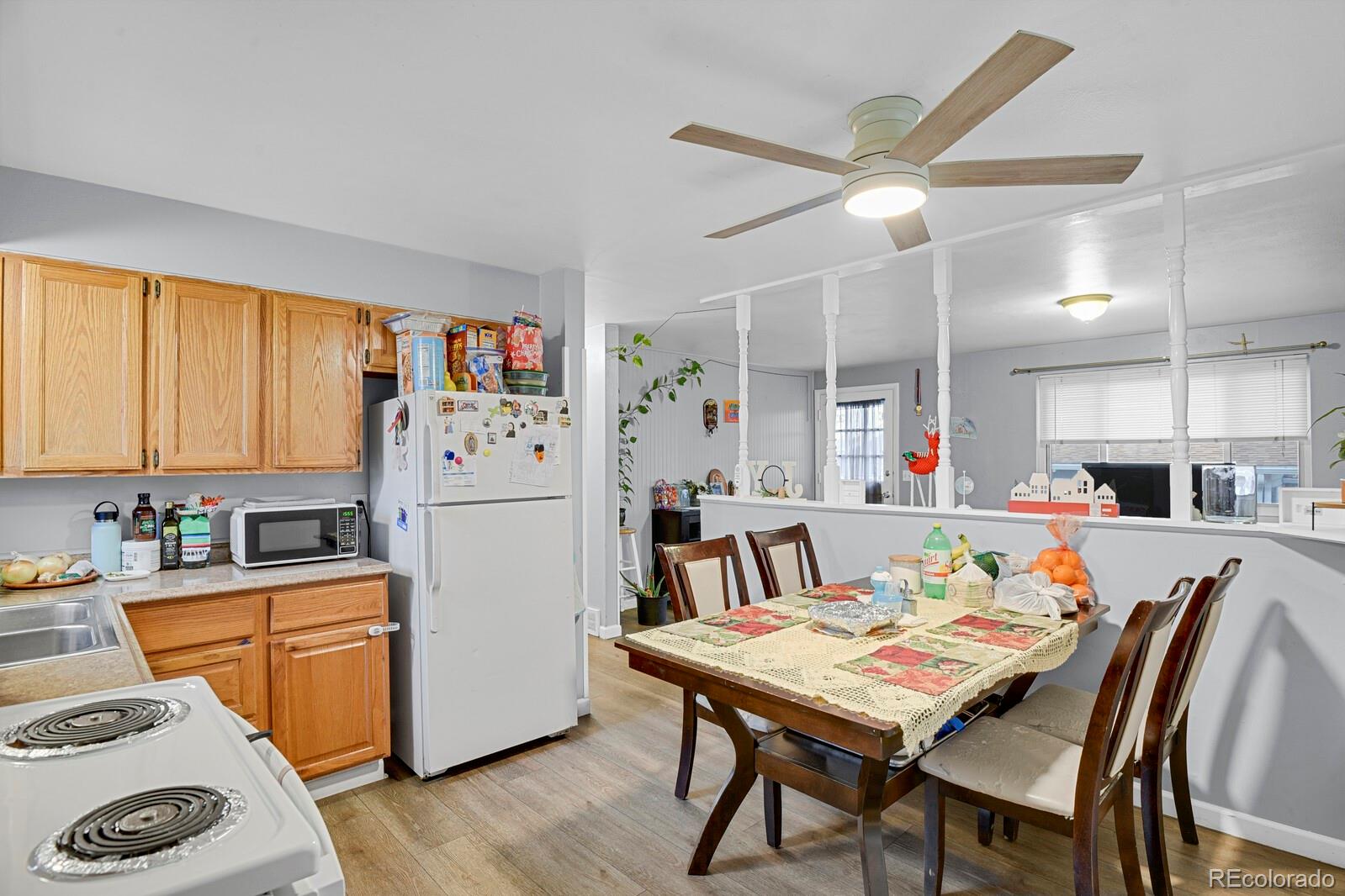 233 South Decatur Street Denver, CO 80219 - Photo 9 of 35 a kitchen with a table chairs refrigerator and a window
