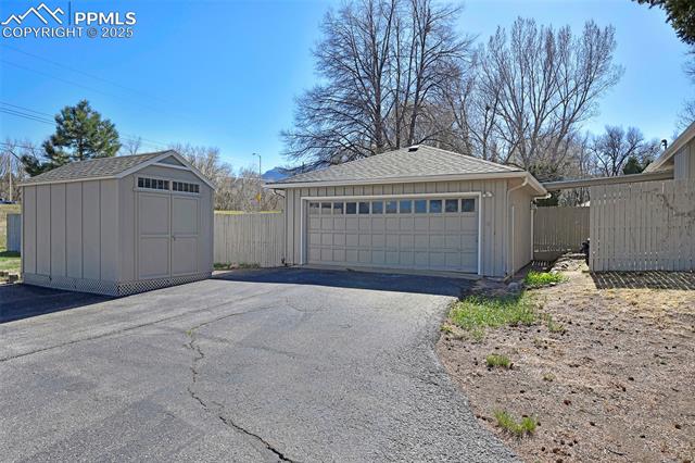 2421 Strickler Road Colorado Springs, CO 80906 - Photo 26 of 44 Detached garage with fence