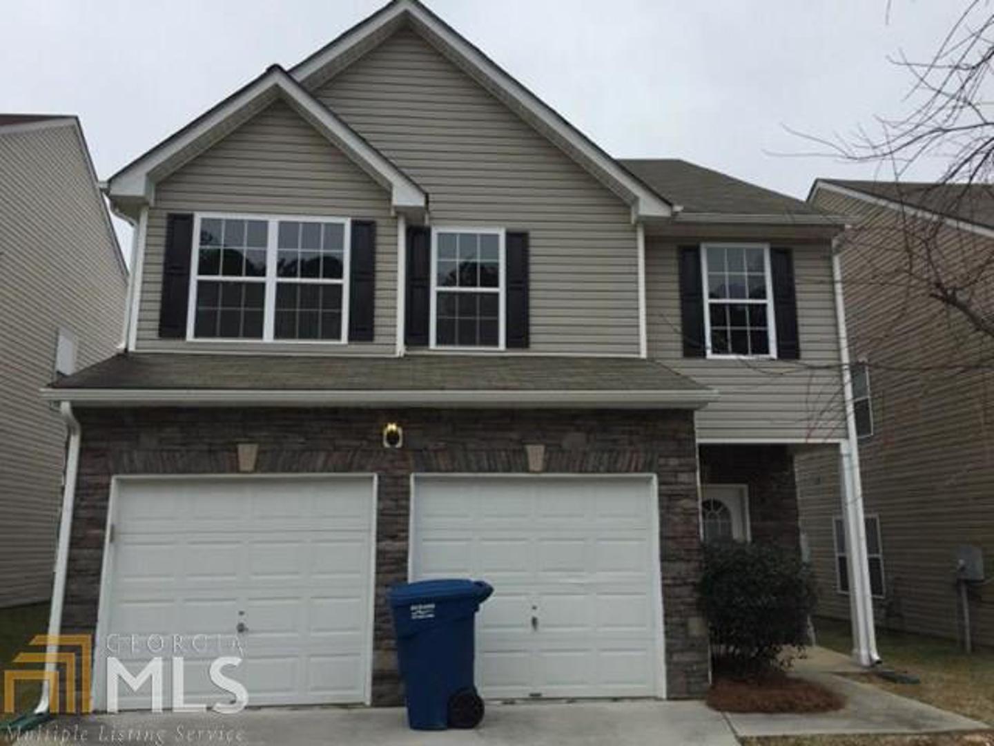 5808 Little River Road Atlanta, GA 30349 - Photo 1 of 1 a front view of a house with parking