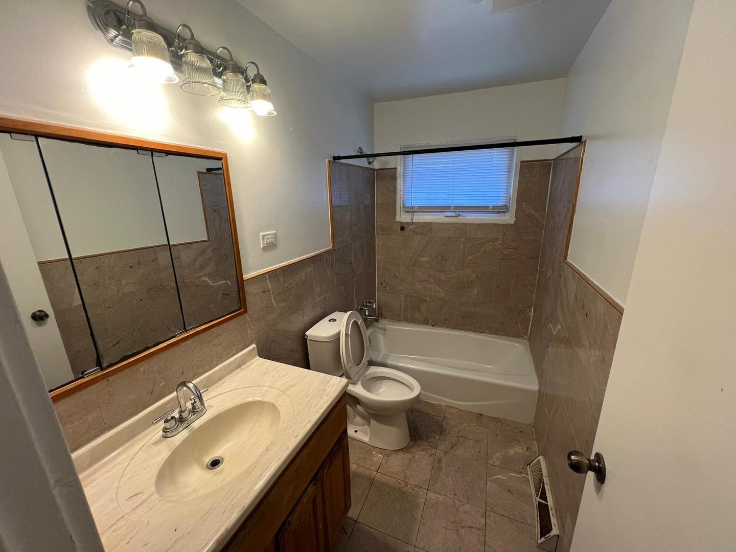 16442 Honore Avenue Markham, IL 60428 - Photo 15 of 16 a bathroom with a sink a toilet and shower