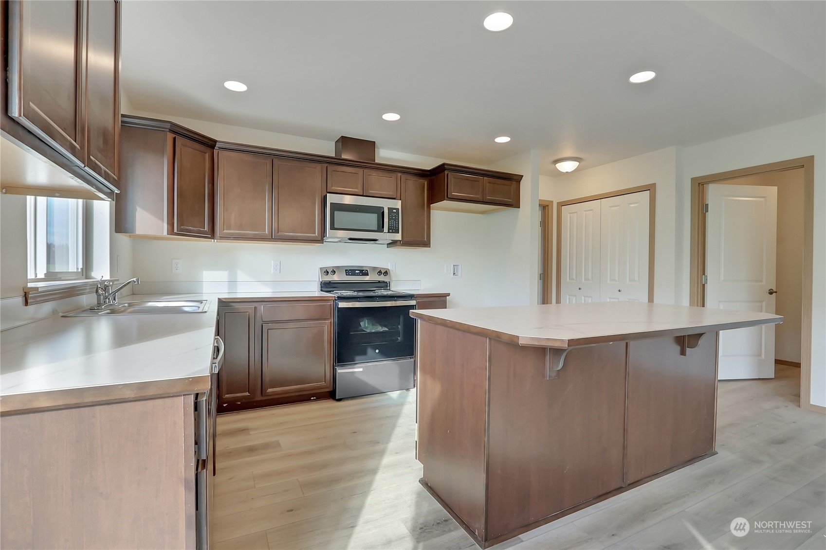 114 Gunnell Road Winlock, WA 98596 - Photo 4 of 23 a kitchen with kitchen island a sink stainless steel appliances and cabinets